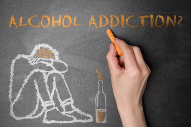 Image of Alcohol addiction? - We can help you. Closeup view of woman writing with chalk on blackboard