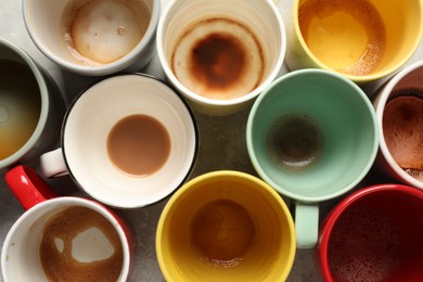 Photo of Many dirty cups after different coffee drinks on light grey table, flat lay