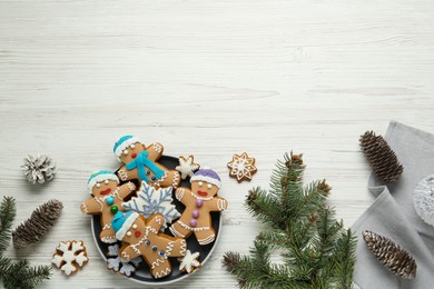 Photo of Delicious Christmas cookies, pine cones and fir branches on white wooden table, flat lay. Space for text