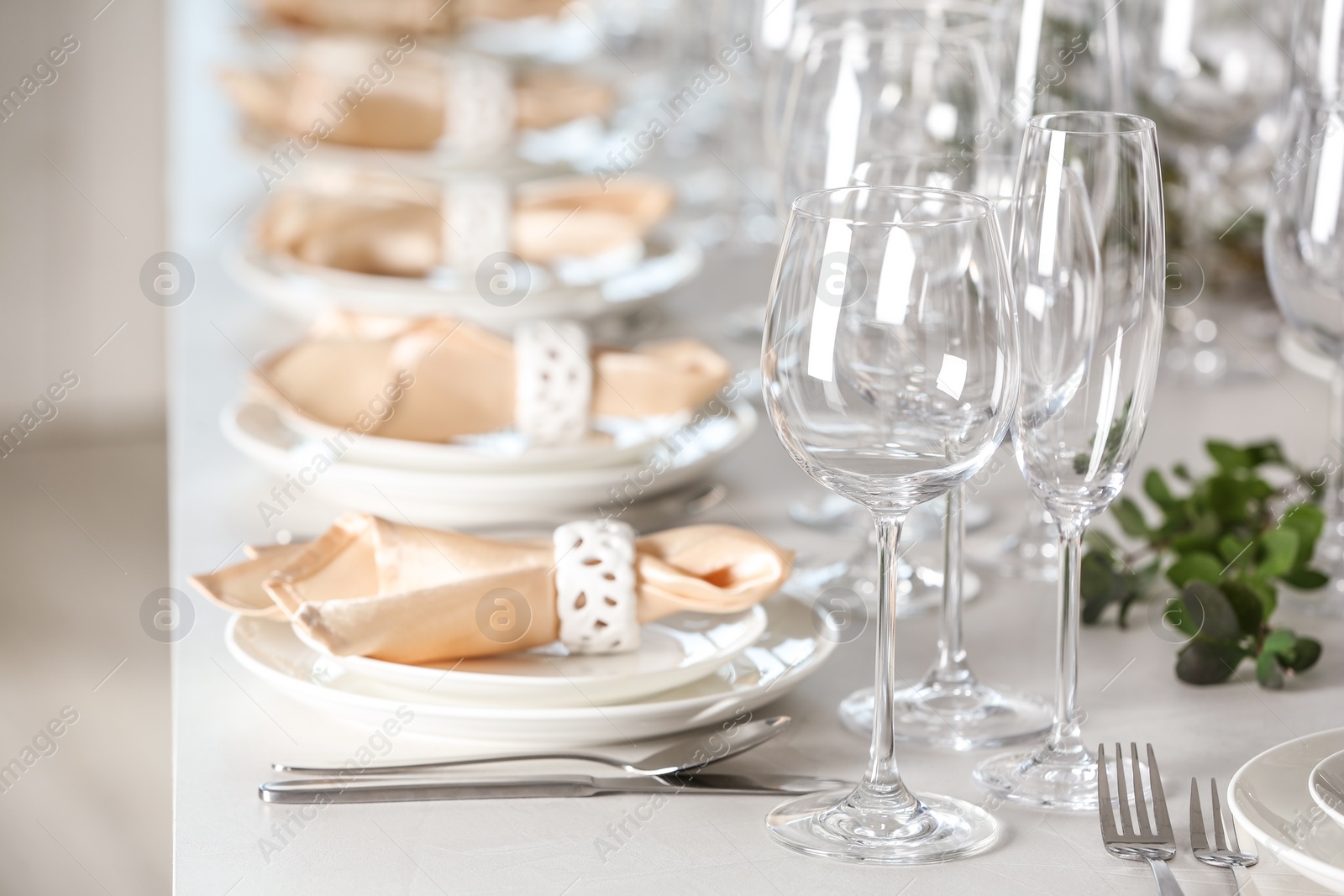 Photo of Table setting with empty glasses, plates and cutlery indoors