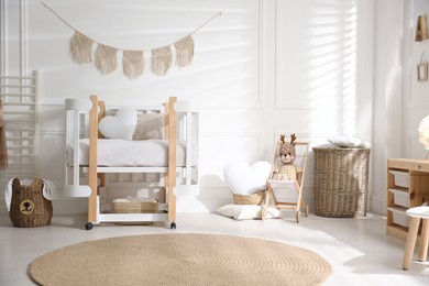 Photo of Baby room interior with stylish furniture and toys