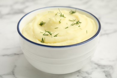 Freshly cooked homemade mashed potatoes on white marble table, closeup