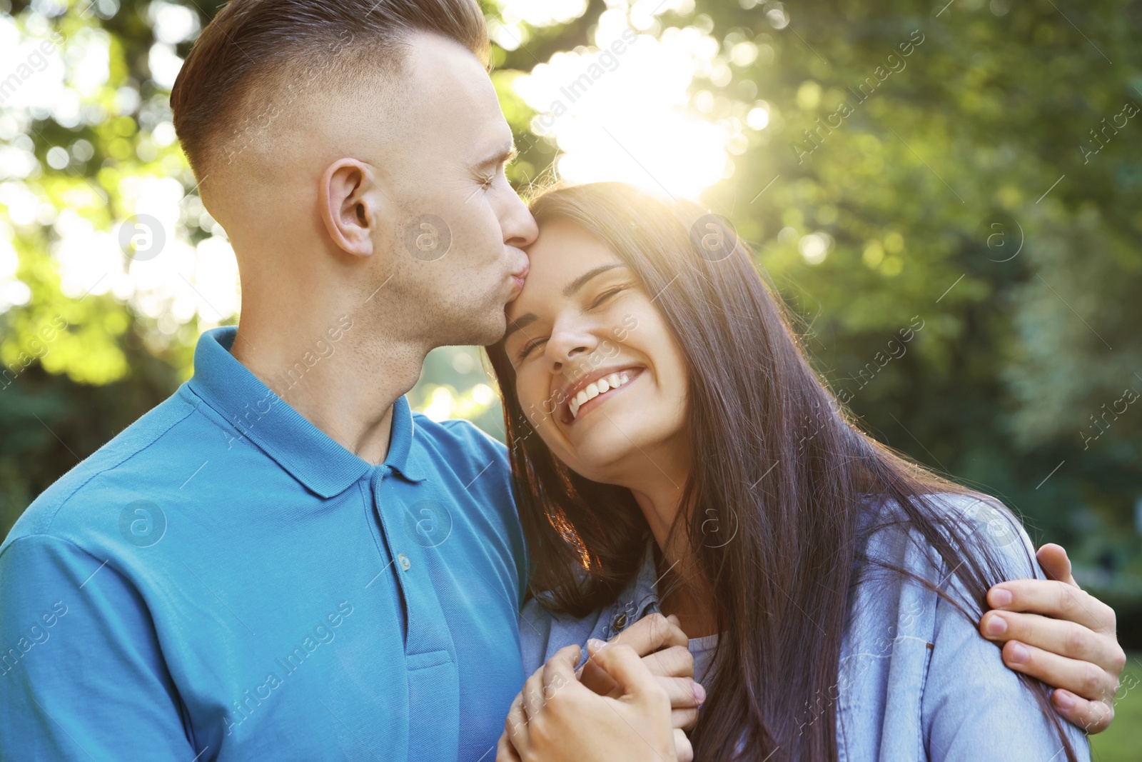 Photo of Happy young couple having good time together in park