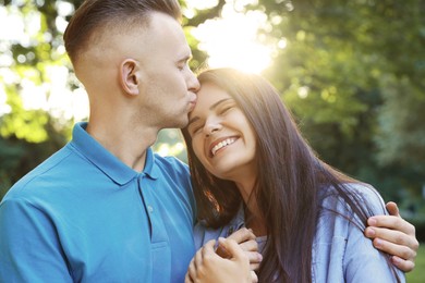 Photo of Happy young couple having good time together in park