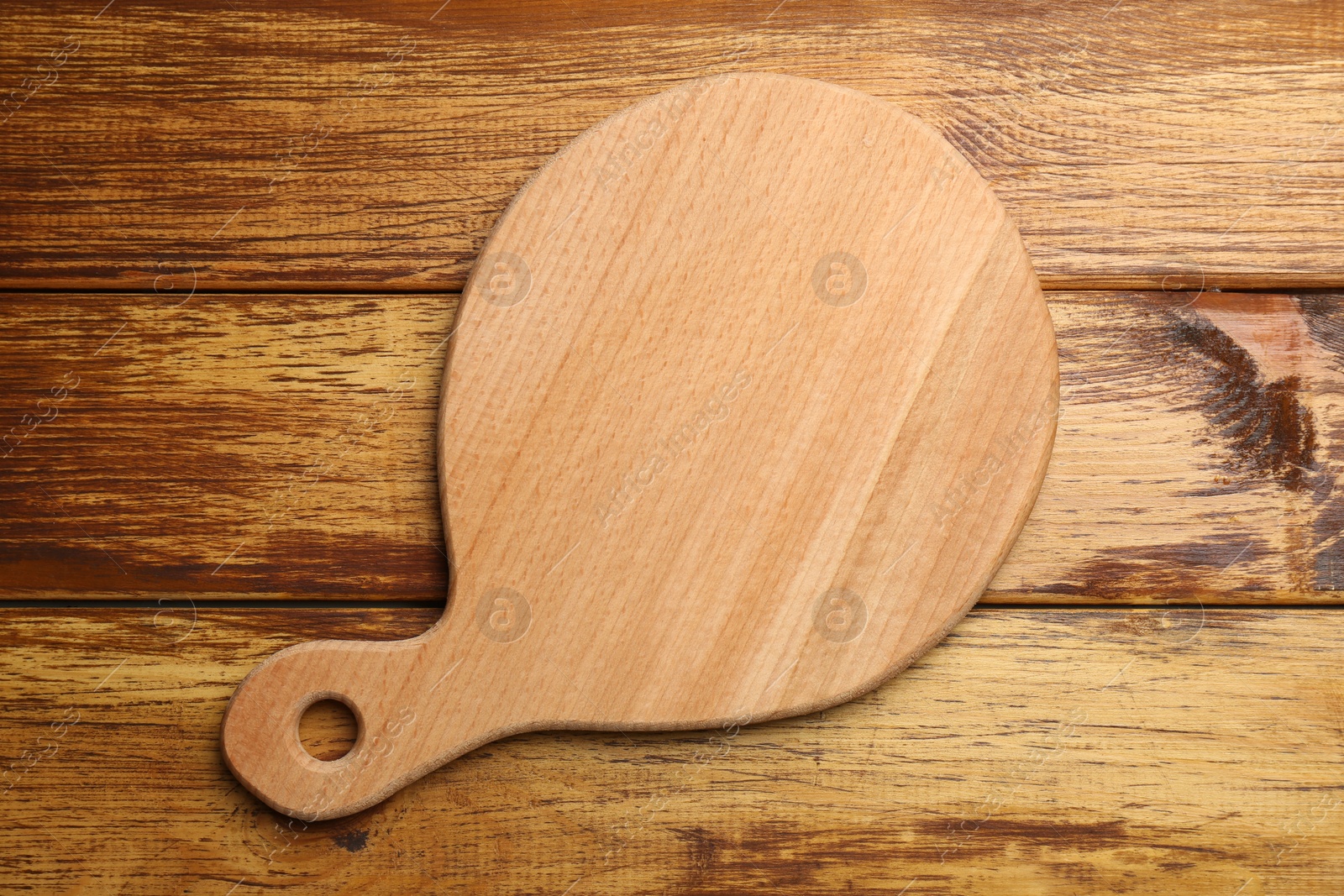 Photo of New cutting board on wooden table, top view