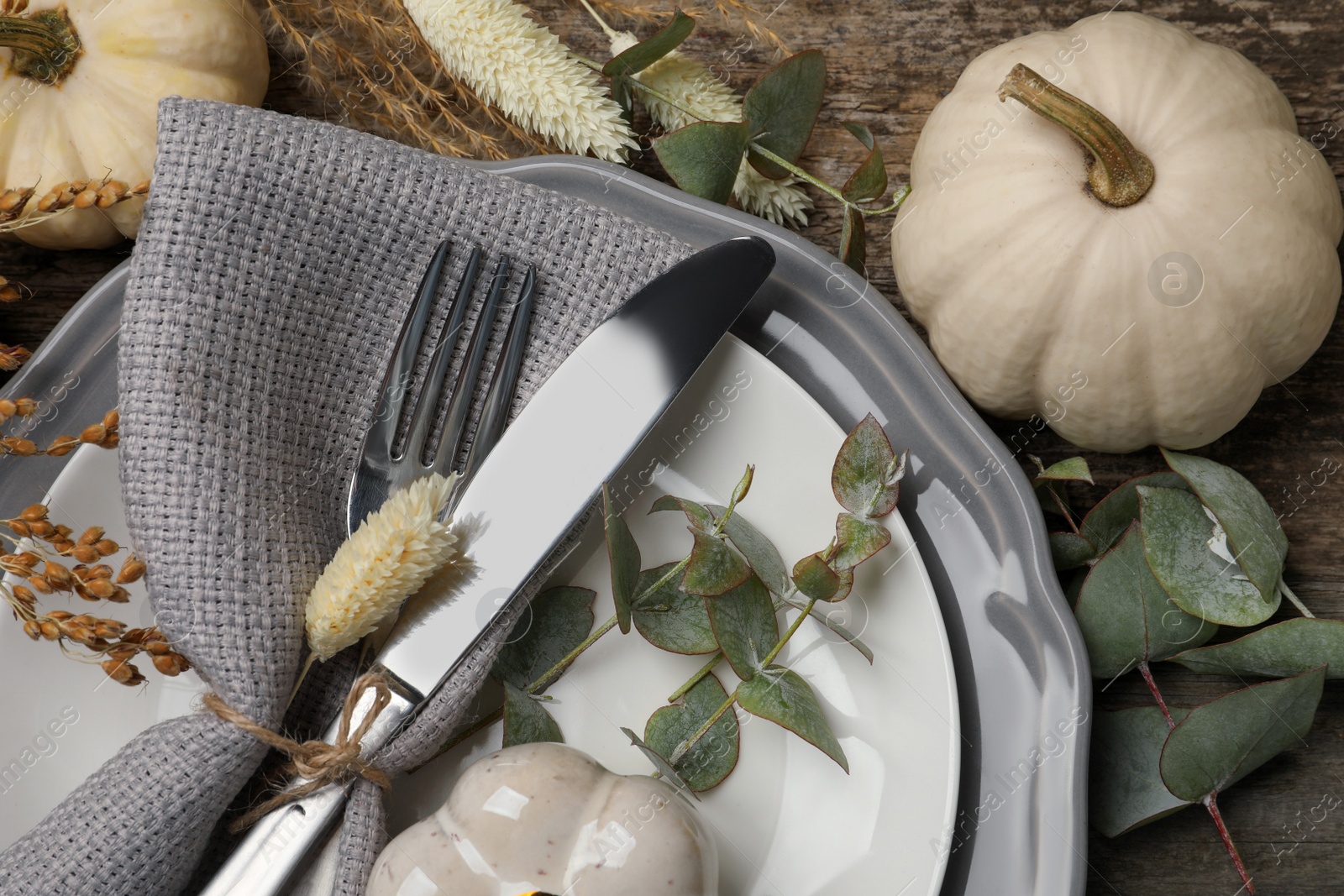 Photo of Festive table setting with autumn decor on wooden background, flat lay