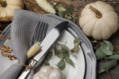 Photo of Festive table setting with autumn decor on wooden background, flat lay