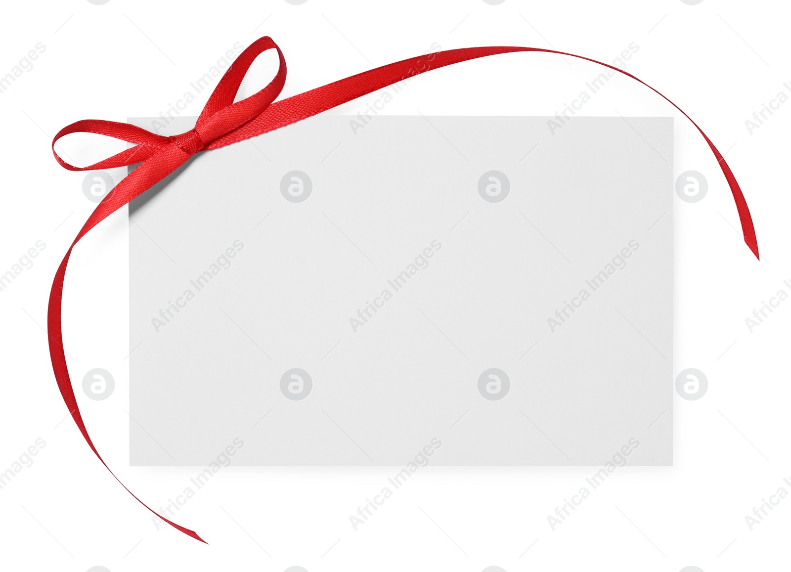 Photo of Blank gift card with red bow isolated on white, top view