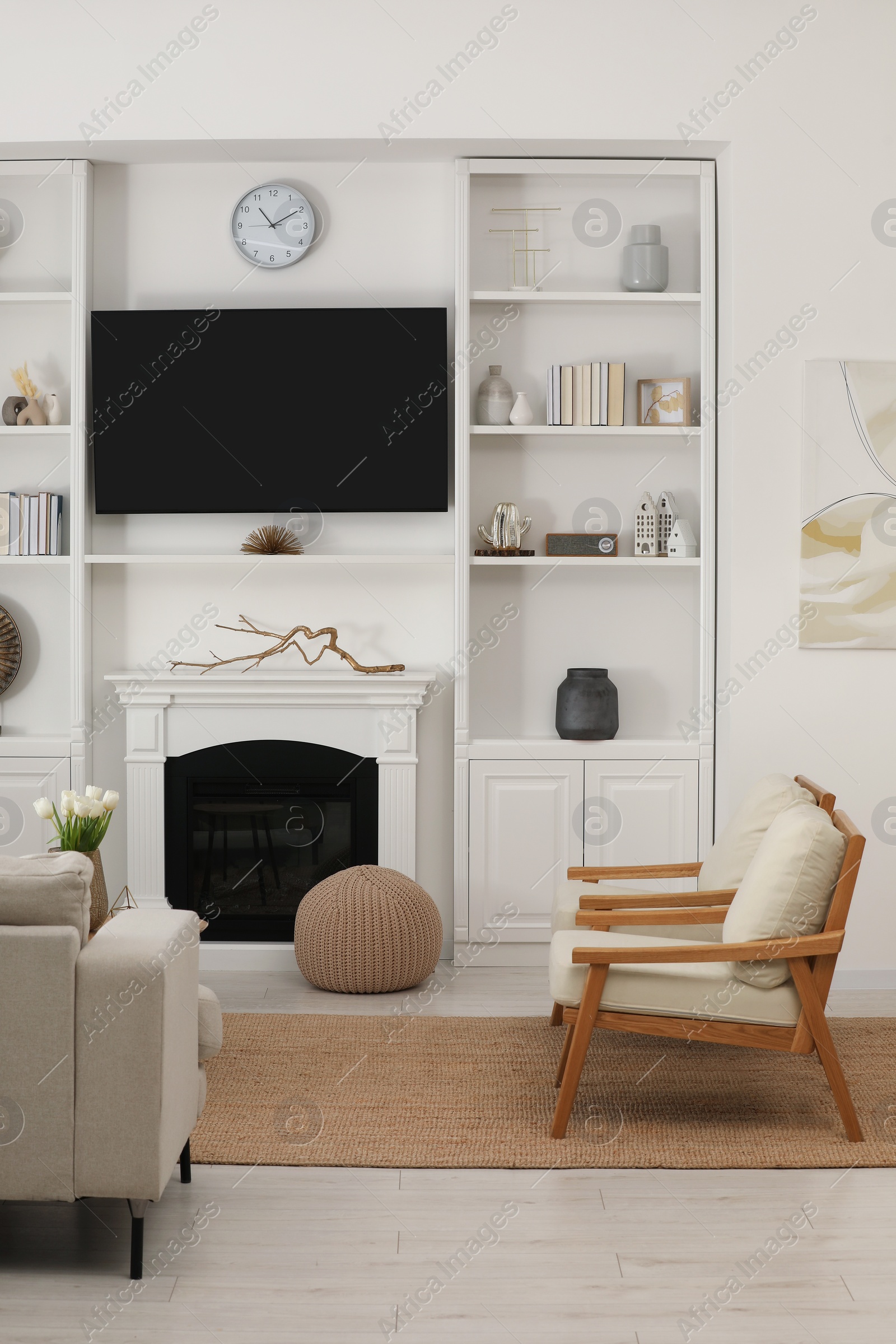 Photo of Cozy room interior with stylish furniture, decorative fireplace and TV set