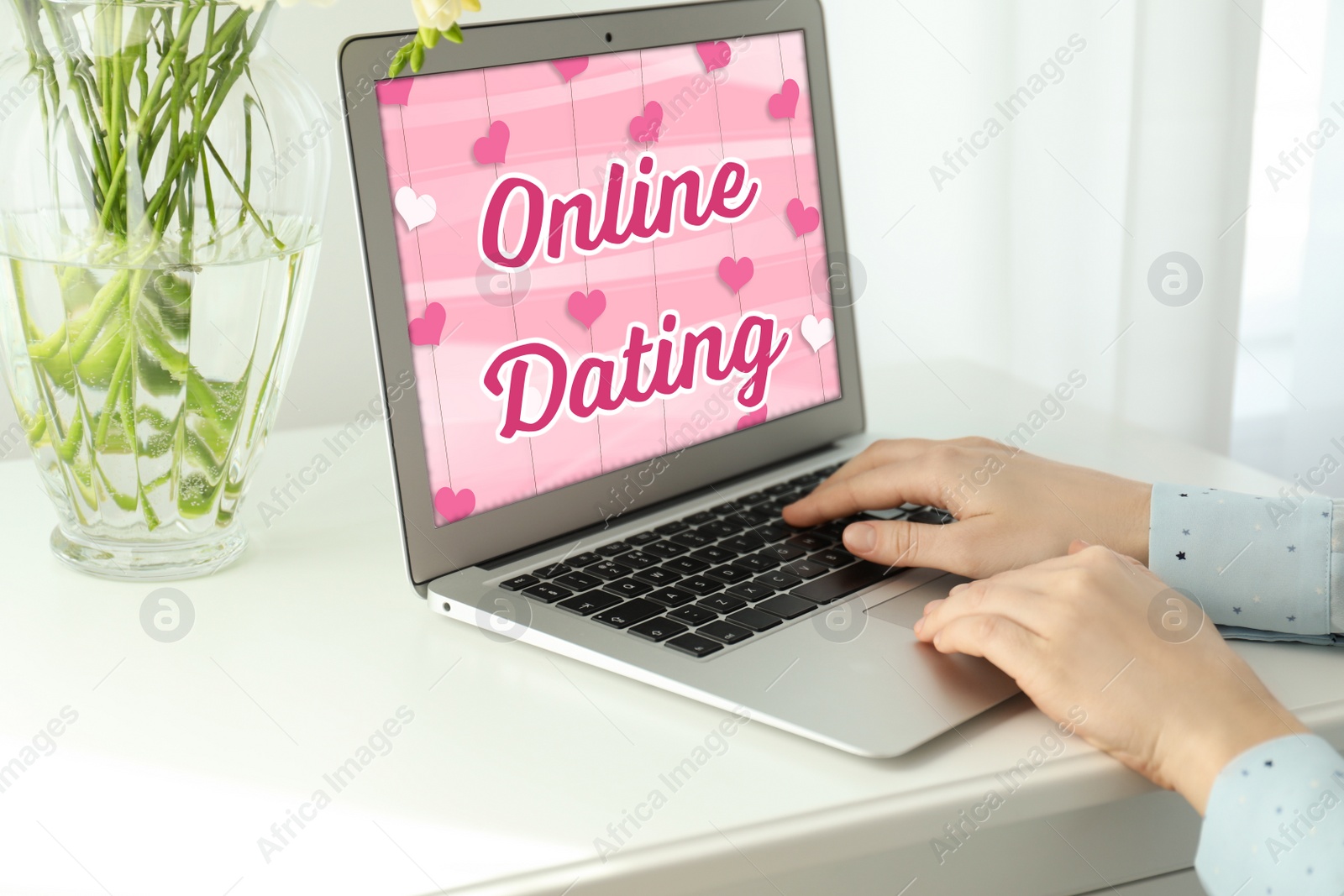 Image of Woman visiting dating site via tablet at white table indoors, closeup