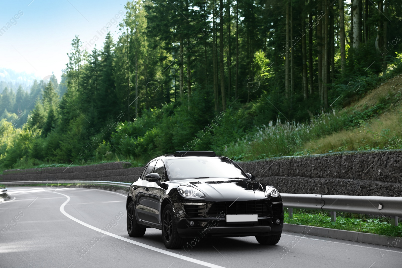 Photo of Picturesque view of asphalt road with modern black car outdoors