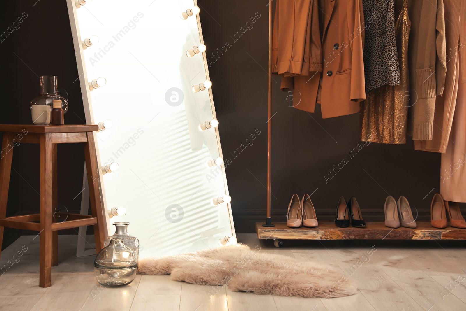 Photo of Stylish mirror with light bulbs in dressing room. Interior design