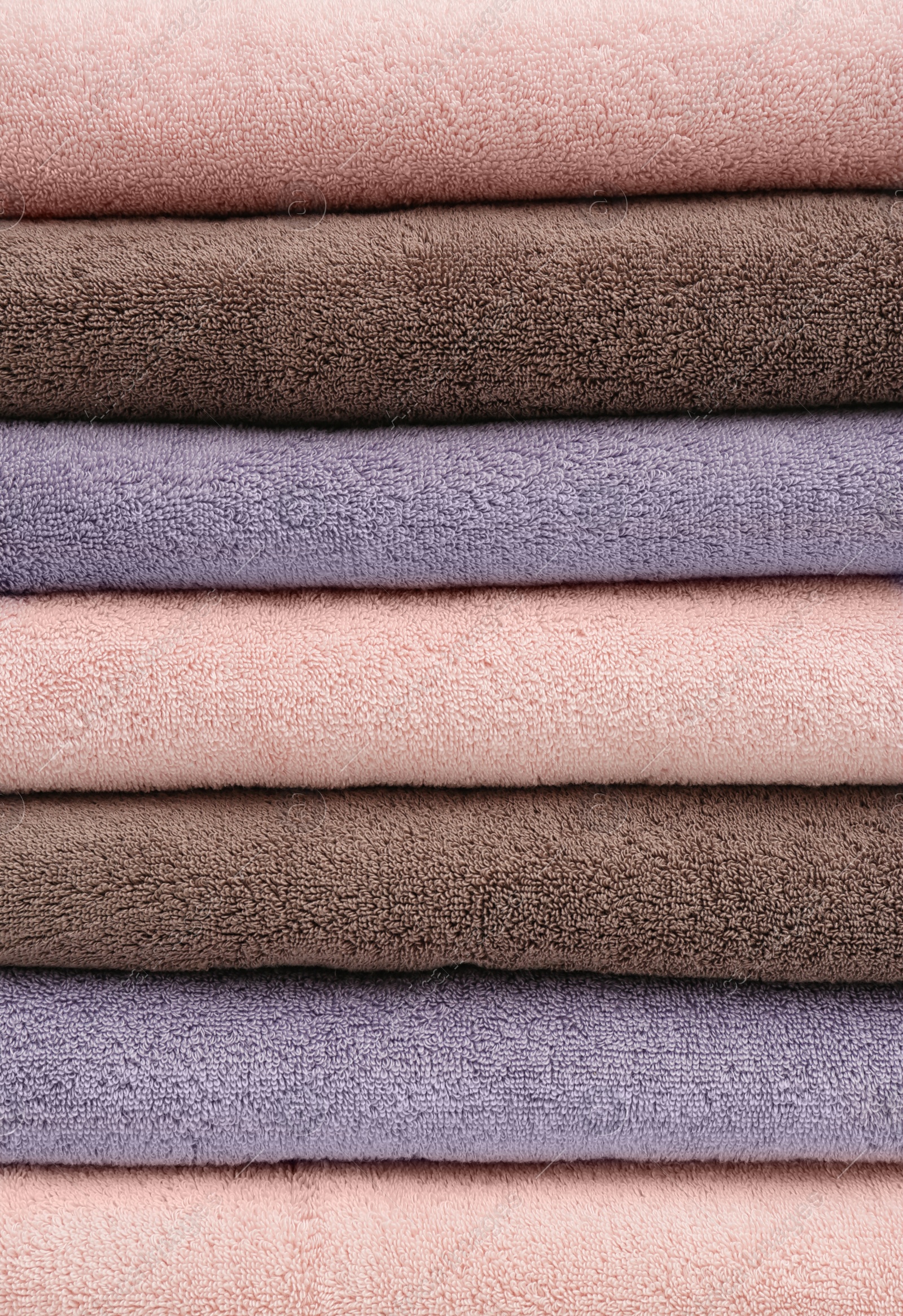 Photo of Stack of folded soft colorful towels as background