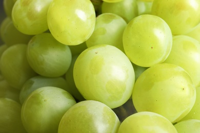 Photo of Bunch of green fresh ripe juicy grapes as background, closeup