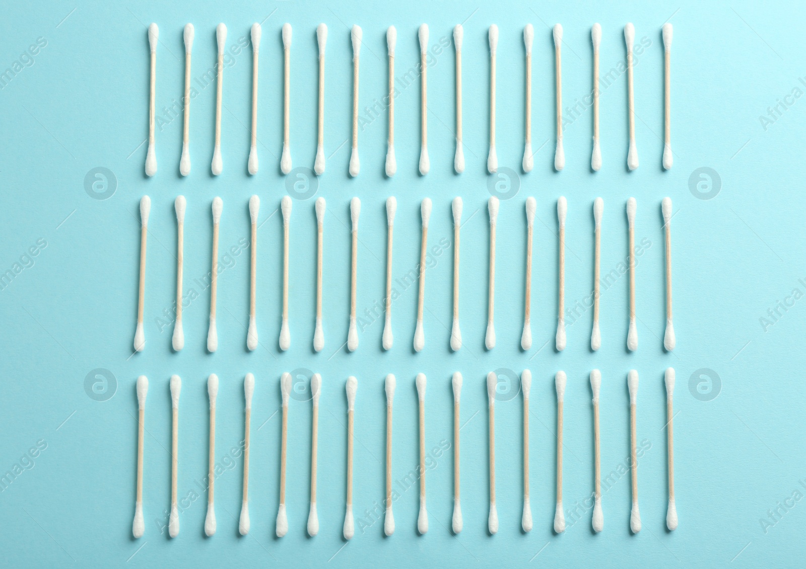 Photo of Flat lay composition with cotton swabs on color background