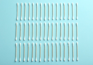 Flat lay composition with cotton swabs on color background