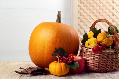 Photo of Happy Thanksgiving day. Composition with pumpkins and berries on wooden table