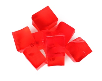 Heap of red jelly cubes on white background, top view