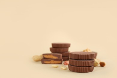 Sweet peanut butter cups on beige background. Space for text