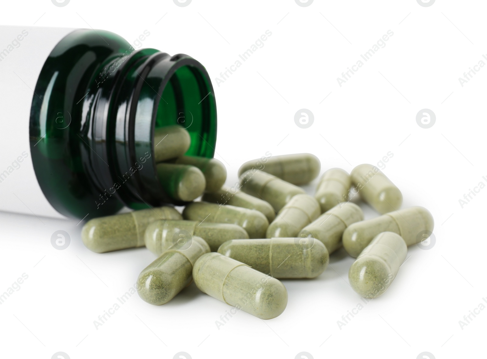 Photo of Scattered vitamin capsules and bottle isolated on white