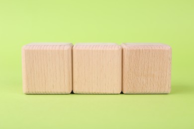 Photo of International Organization for Standardization. Wooden cubes with abbreviation ISO on light green background, closeup