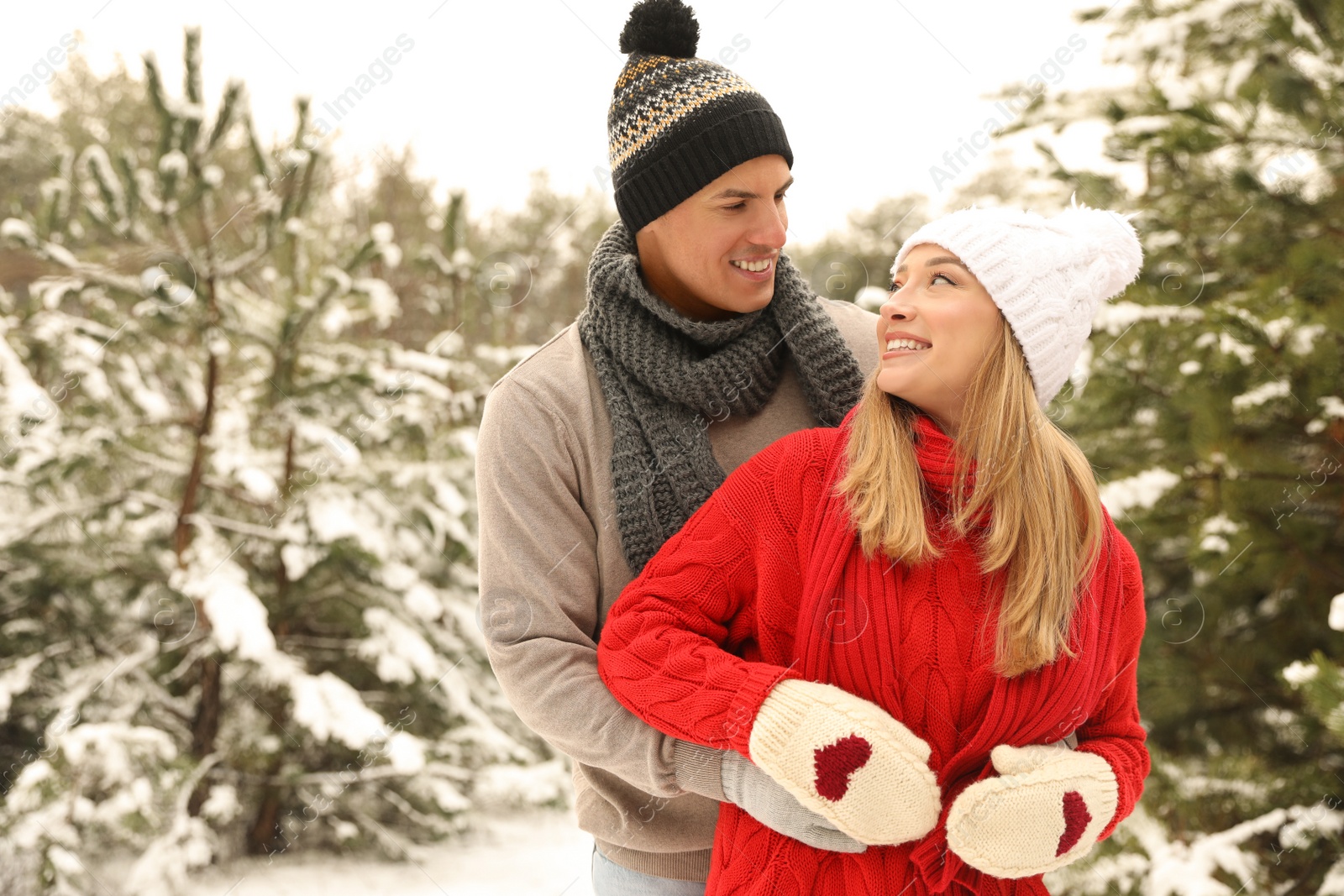 Photo of Beautiful happy couple in snowy forest on winter day