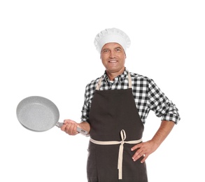 Mature male chef holding frying pan on white background