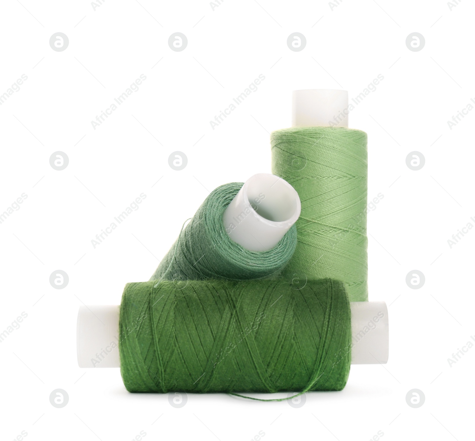 Photo of Different colorful sewing threads on white background