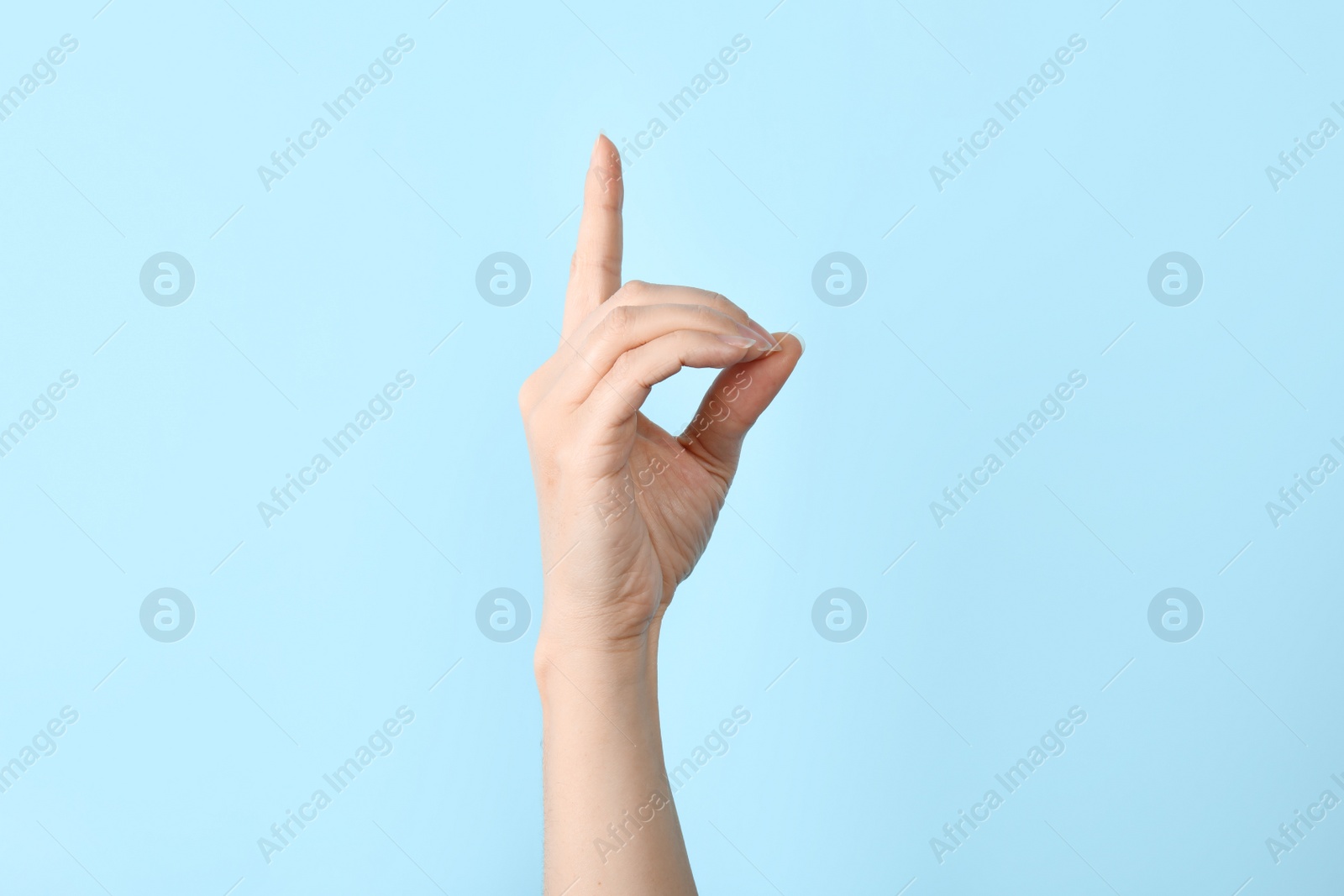 Photo of Woman showing D letter on color background, closeup. Sign language