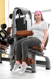 Overweight woman training in gym