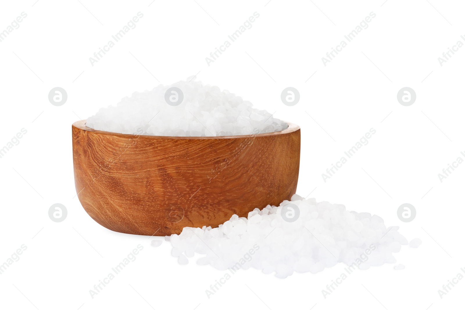 Photo of Wooden bowl and heap of natural sea salt isolated on white