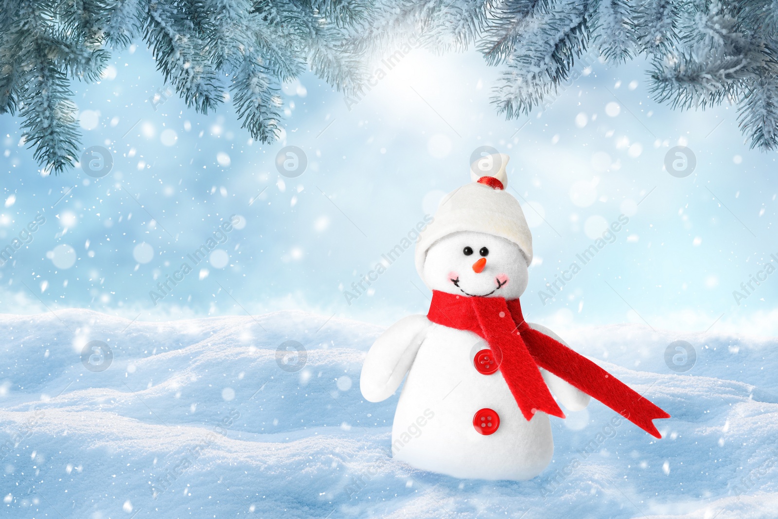 Image of Cute decorative snowman in hat and scarf outdoors on snowy day, space for text