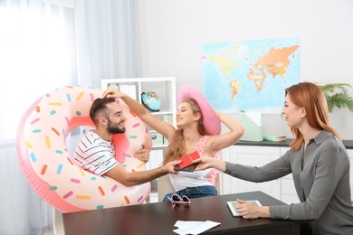 Photo of Beautiful young couple visiting travel agency office