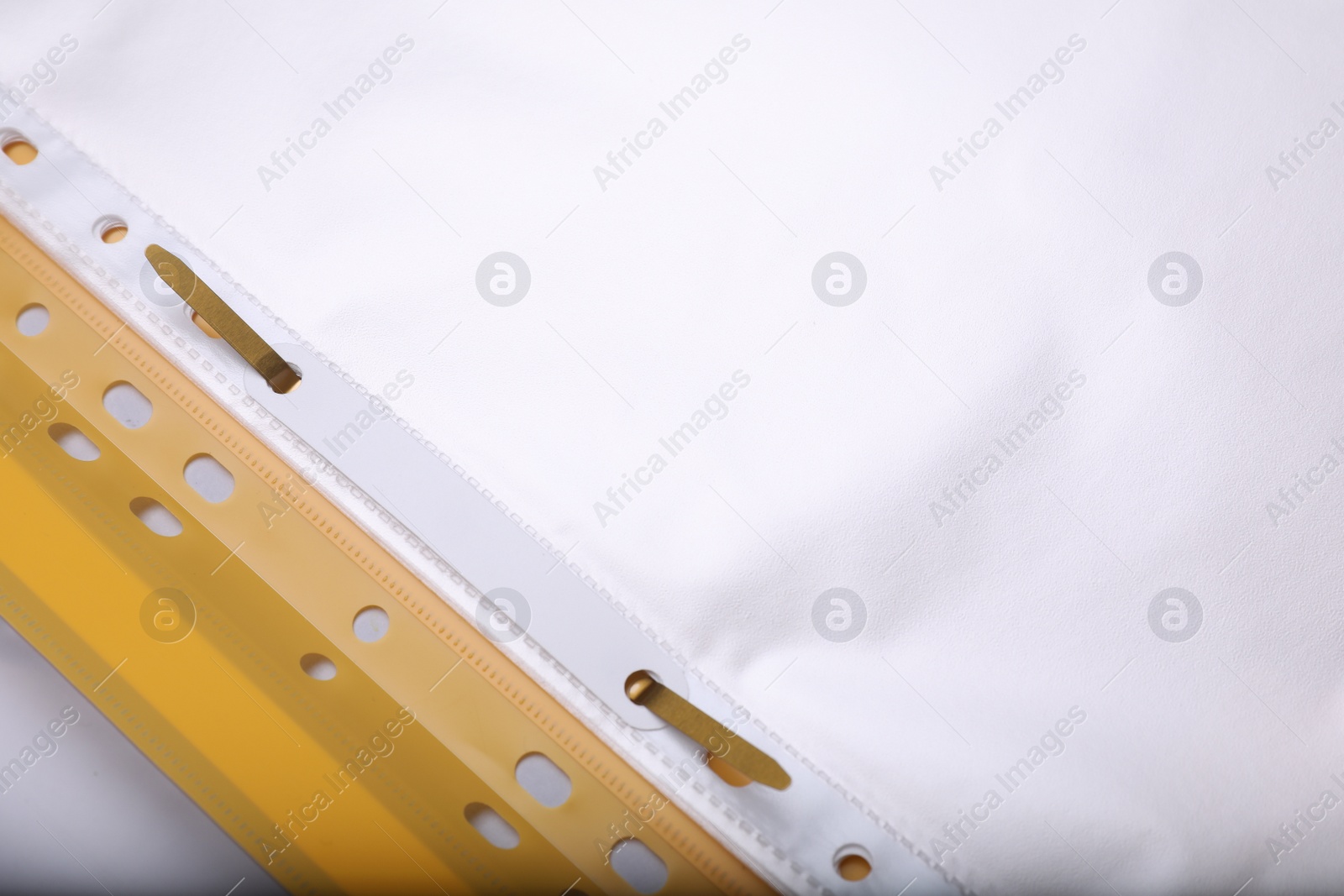 Photo of File folder with punched pockets on light grey background, closeup