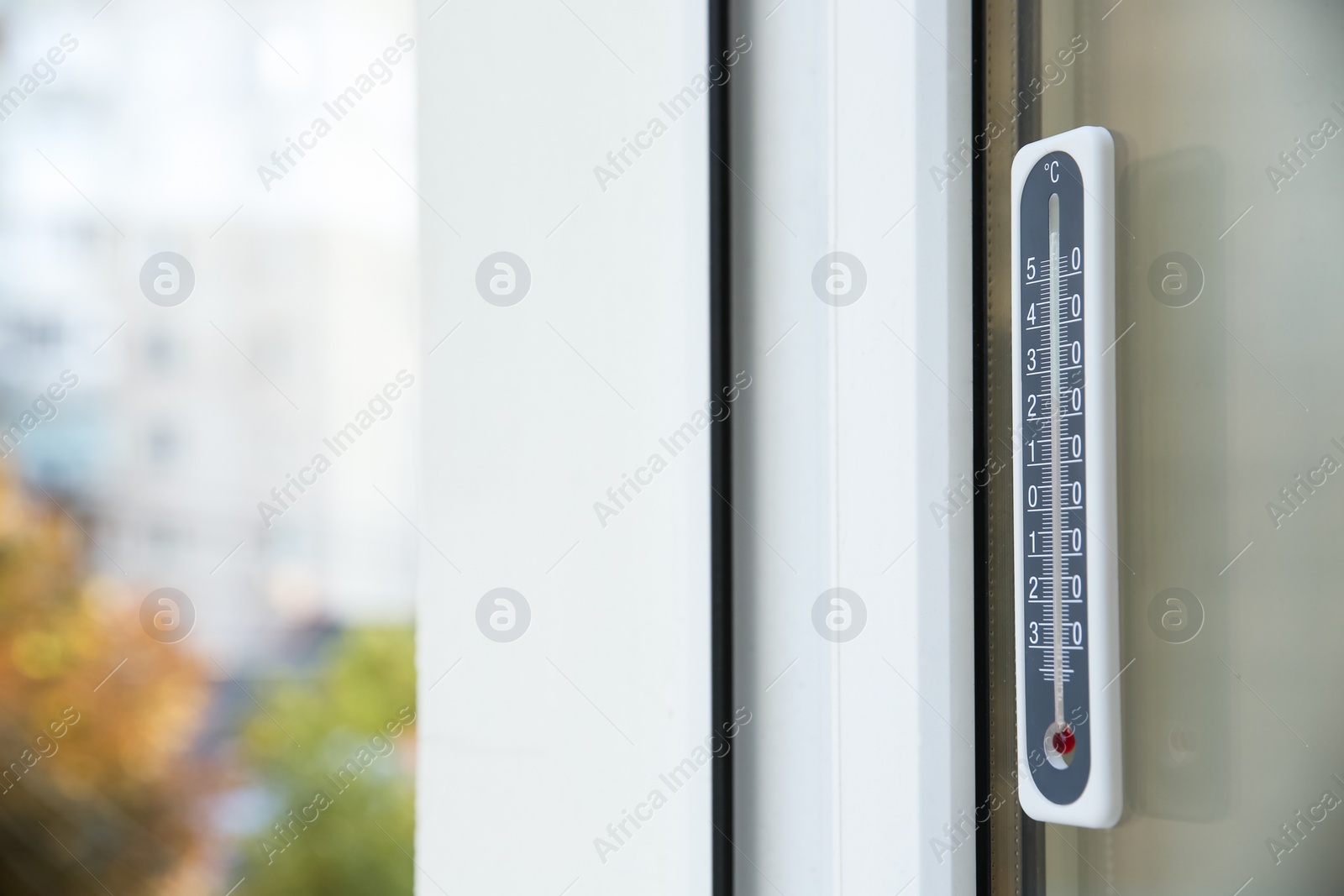 Photo of Weather thermometer on outside window. Space for text