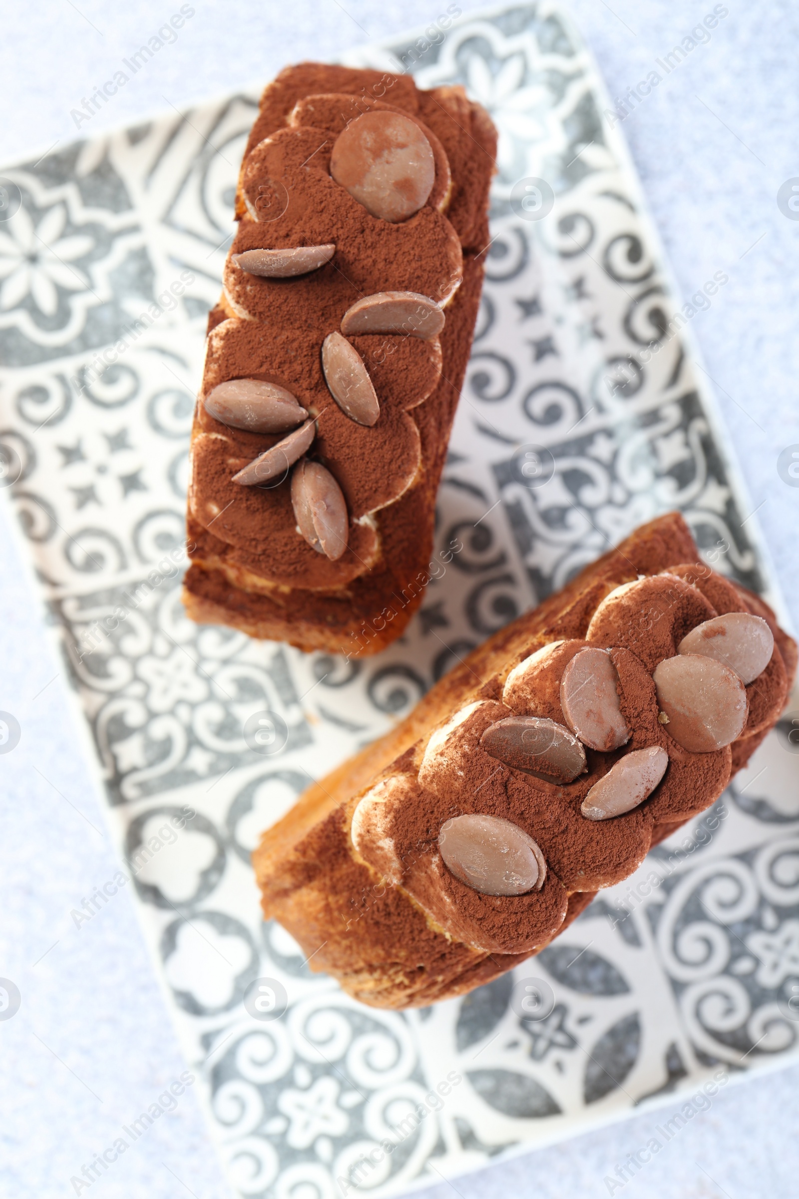 Photo of Supreme croissants with chocolate chips and cream on grey table, top view. Tasty puff pastry