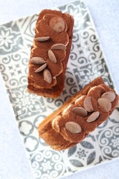 Photo of Supreme croissants with chocolate chips and cream on grey table, top view. Tasty puff pastry