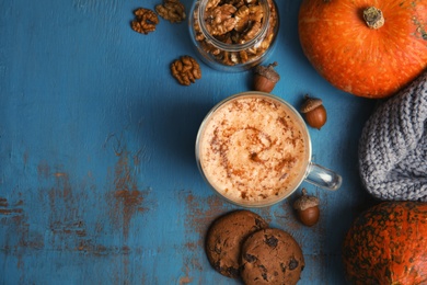 Photo of Flat lay composition with pumpkin spice latte and space for text on wooden background