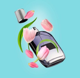 Bottle of perfume and tulips in air on light blue background