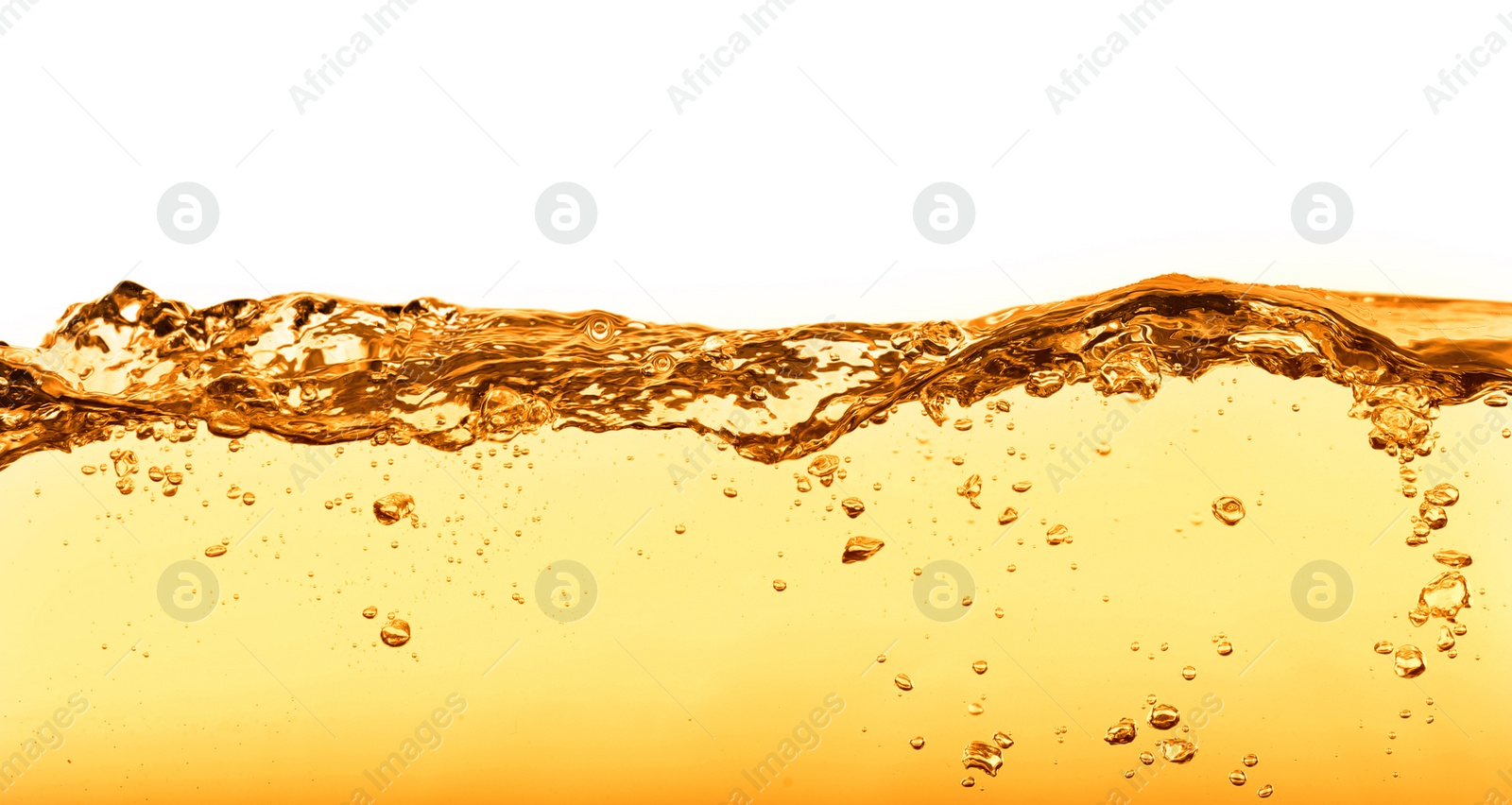 Image of Golden oily liquid splash on white background