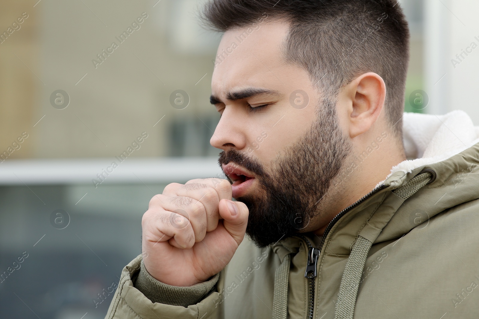 Photo of Sick man coughing outdoors, space for text. Cold symptoms