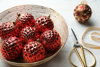 Composition with beautiful Christmas baubles on white wooden table