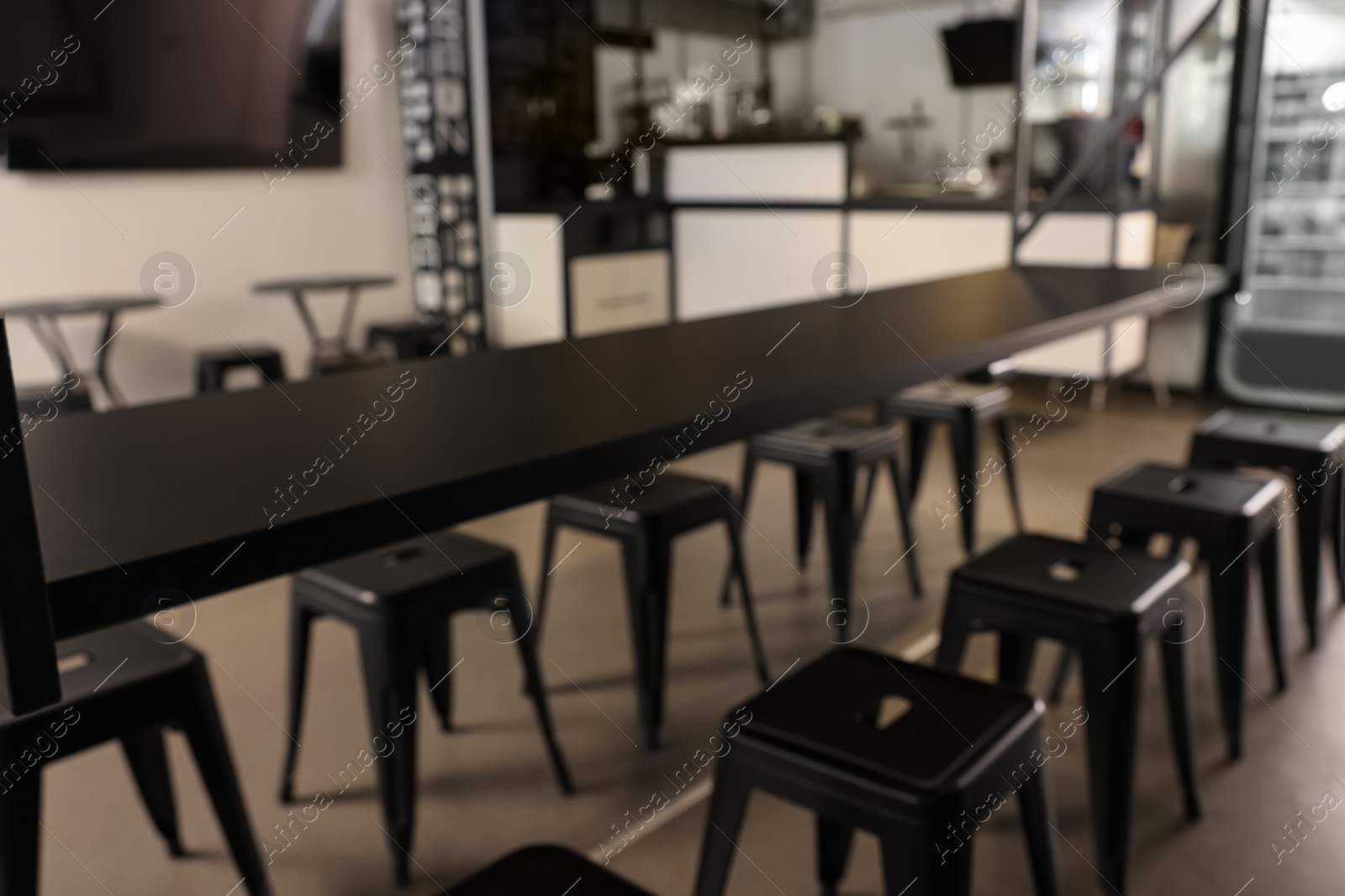 Photo of Blurred view of hostel dining room interior with comfortable furniture and coffee shop