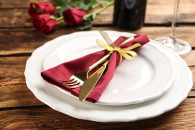 Photo of Beautiful table setting for Valentine's Day dinner on wooden background