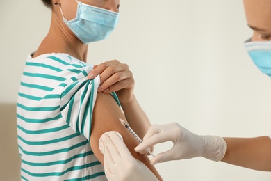 Photo of Doctor giving injection to patient in hospital, closeup. Vaccination day