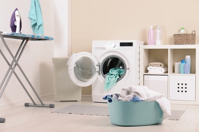 Basket with dirty towels in laundry room