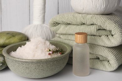 Photo of Composition with different spa products on white table against wooden background, closeup