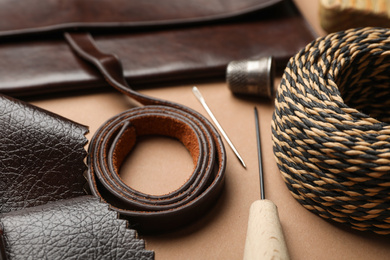 Photo of Leather samples and tools on table, closeup
