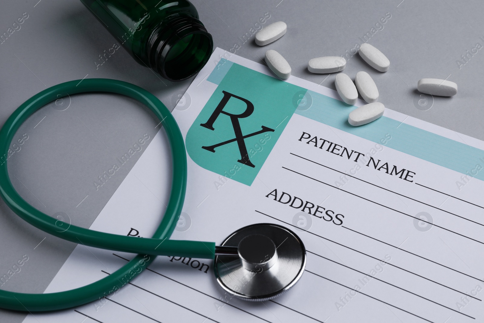 Photo of Medical prescription form, stethoscope and pills on light grey background, closeup