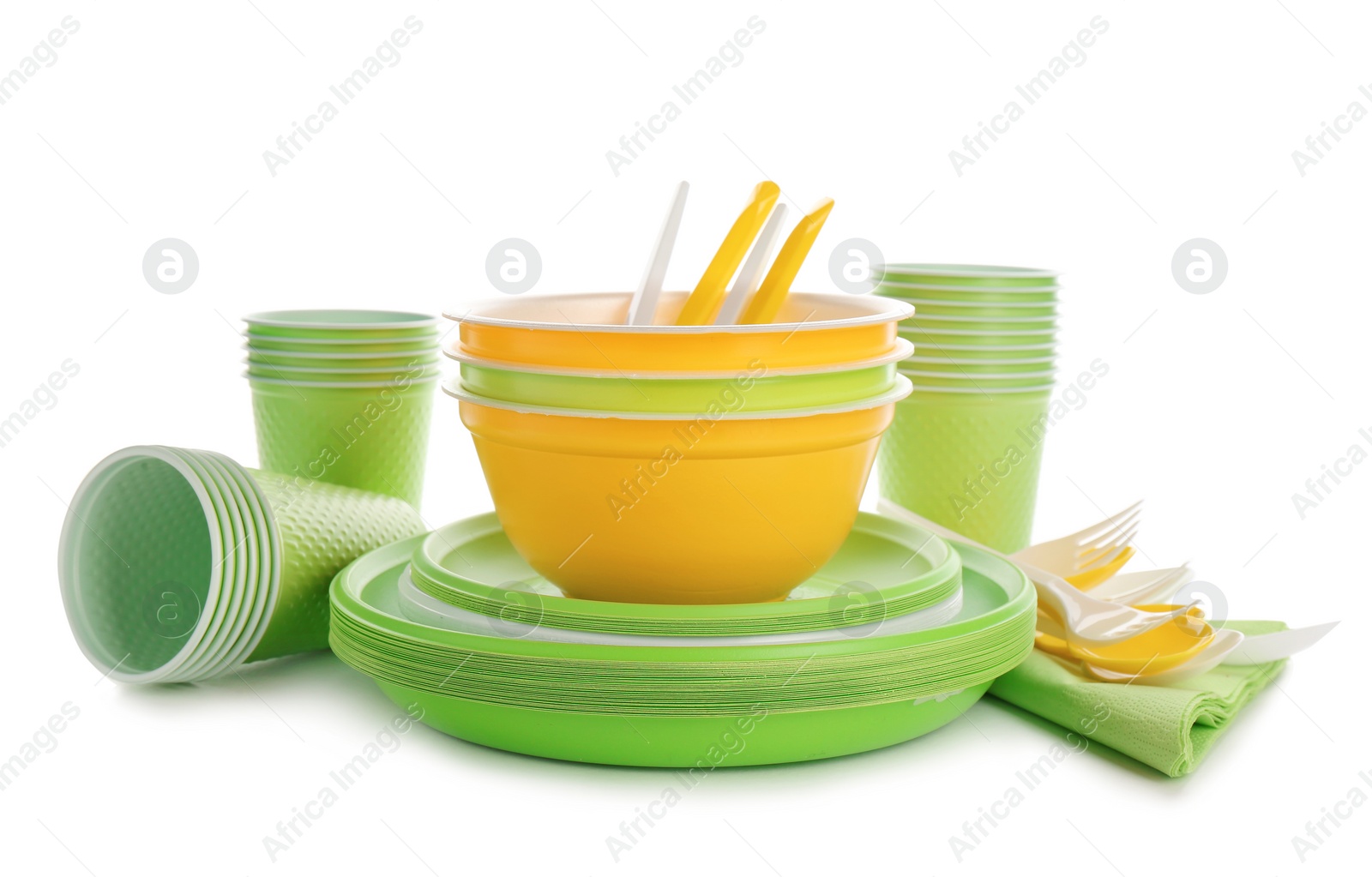 Photo of New plastic dishware and napkins on white background. Table setting